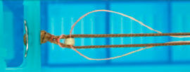 Bead being knotted to cord
